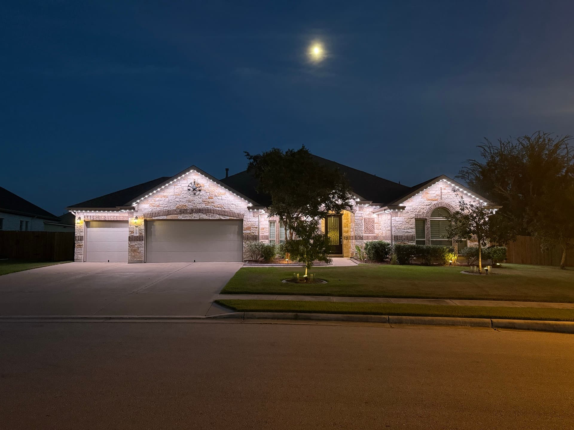 Well-designed permanent lighting highlighting architecture on an Austin Hill Country home