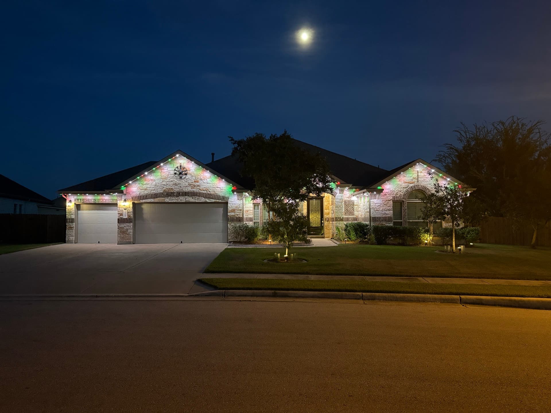 TruLight permanent lighting displaying team colors on an Austin home for game day