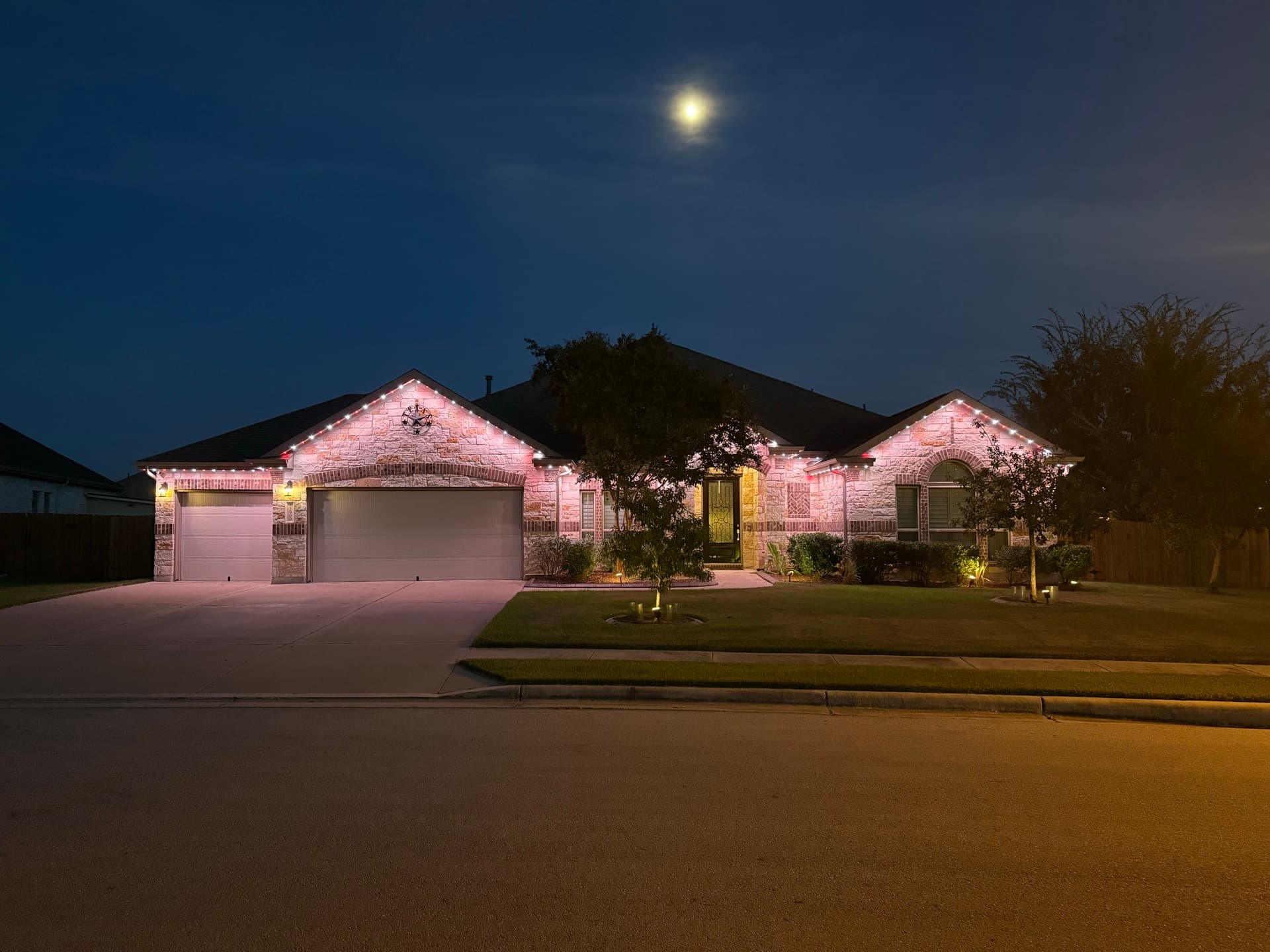 Permanent lighting displaying holiday colors on an Austin home showing year-round versatility
