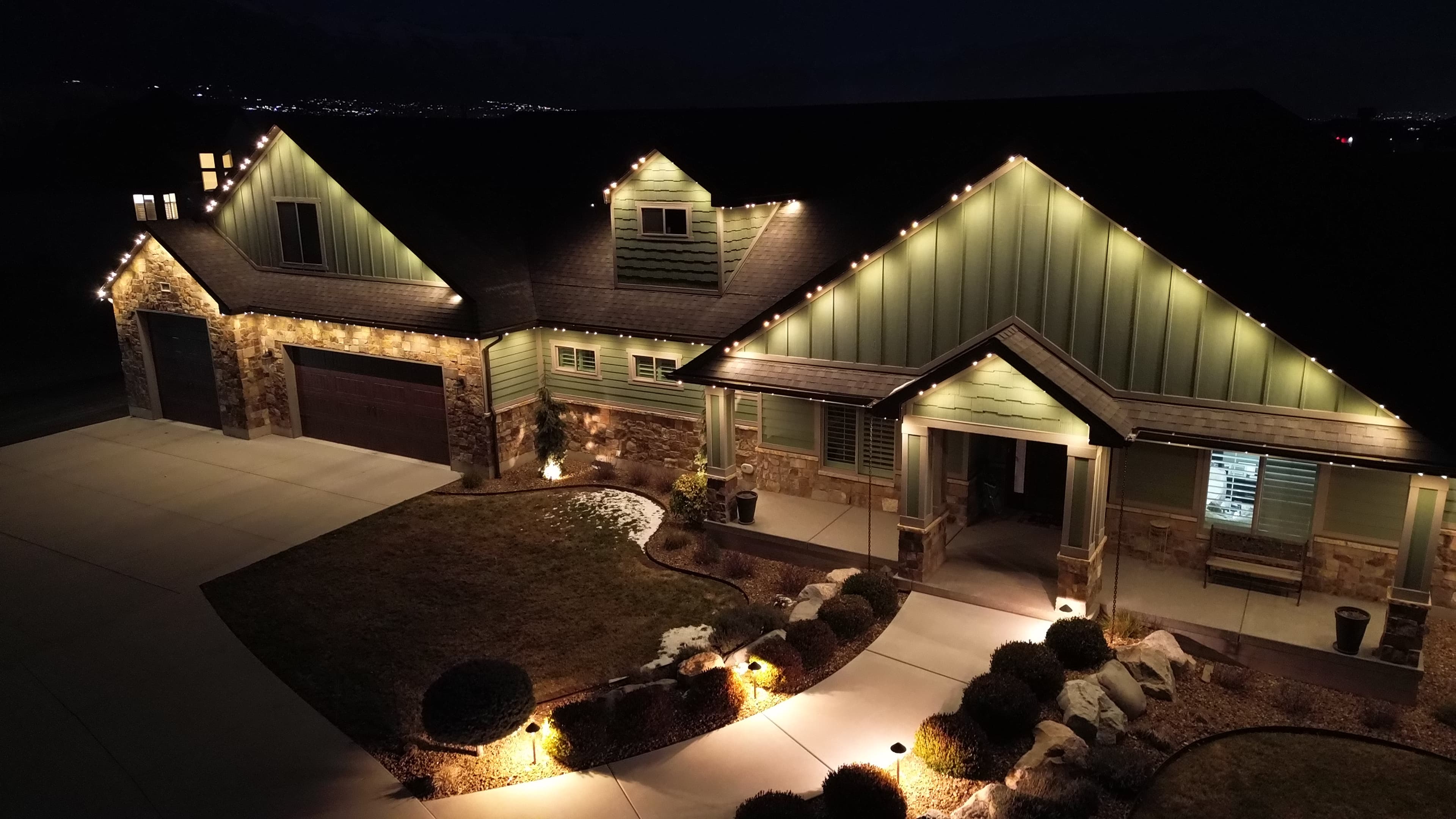 Roofline lighting installation on an Austin home at dusk
