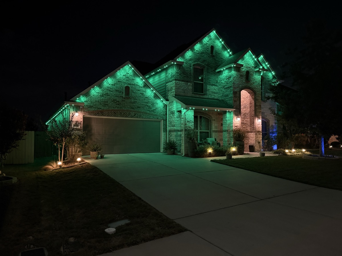 Aerial view of permanent lighting enhancing an Austin home's resale presentation